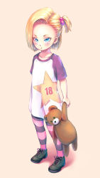 Rule 34 | 1girl, aged down, android 18, blonde hair, blue eyes, blush, character name, child, copyright name, dragon ball, eply, full body, hair bobbles, hair ornament, holding, pantyhose, shirt, short hair, short sidetail, solo, striped clothes, striped pantyhose, stuffed animal, stuffed toy, t-shirt, teddy bear