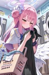 Rule 34 | 1girl, angel wings, black scrunchie, blue archive, blush, capelet, clothes dryer, feathered wings, frilled ribbon, frills, hair bun, halo, highres, holding, holding clothes, holding shirt, laundromat, laundry, laundry basket, low wings, mika (blue archive), pink hair, pink halo, ribbon, scrunchie, shirt, single side bun, solo, superpig, washing machine, white capelet, white wings, wing ornament, wings, wrist scrunchie