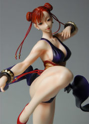 Rule 34 | 1girl, alternate costume, bare shoulders, braid, breasts, capcom, china dress, chinese clothes, chun-li, cleavage, dress, female focus, figure, kicking, large breasts, legs up, photo (medium), short hair, solo, street fighter, street fighter iv (series)