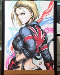 Rule 34 | blonde hair, blue eyes, cammy white, crop top, from behind, gloves, highres, jacket, long sleeves, scar, scar on face, short hair, stanley lau, street fighter, street fighter 6, union jack