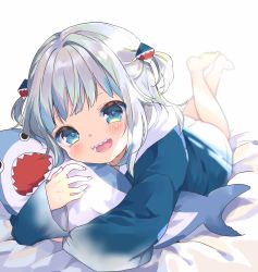 Rule 34 | 1girl, blue eyes, blurry, depth of field, feet up, gawr gura, highres, hololive, hololive english, kosuzume, lying, on stomach, open mouth, sharp teeth, silver hair, sleeves past wrists, smile, solo, stuffed animal, stuffed shark, stuffed toy, teeth, two side up, virtual youtuber