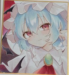 1girl ascot blue_hair blush closed_mouth gem glint grey_hat grey_shirt hair_between_eyes hat highres looking_at_viewer mob_cap moni_monico photo_(medium) pink_eyes red_ascot remilia_scarlet shikishi shirt short_hair smile solo split_mouth touhou traditional_media upper_body