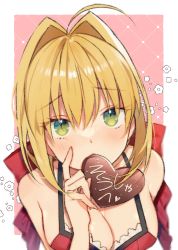 Rule 34 | 1girl, ahoge, ayaka (disagree), blonde hair, border, bow, breasts, candy, chocolate, chocolate heart, cleavage, fate/extra, fate (series), food, green eyes, hair between eyes, hair bow, hair intakes, heart, highres, looking at viewer, medium breasts, mouth hold, nero claudius (fate), nero claudius (fate) (all), nero claudius (fate/extra), outside border, pink background, red bow, short hair, solo, upper body, white border