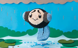 Rule 34 | amigurumi (medium), asako ito, black eyes, closed mouth, commentary, creature, creatures (company), english commentary, full body, game freak, gen 5 pokemon, lily pad, nintendo, no humans, official art, outdoors, photo (medium), pokemon, pokemon (creature), pokemon tcg, rain, smile, solo, third-party source, tympole, unconventional media, water