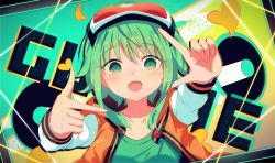 Rule 34 | 1girl, arms up, bad id, bad pixiv id, blush, collarbone, finger frame, goggles, goggles on head, green background, green eyes, green hair, green shirt, gumi, heart, heart background, highres, jacket, long sleeves, looking at viewer, multicolored background, open mouth, orange background, orange jacket, sakakidani, shirt, short hair, sidelocks, smile, solo, upper body, vocaloid