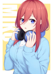 Rule 34 | 1girl, absurdres, text background, blue cardigan, blue eyes, blush, breasts, cardigan, character name, commentary request, go-toubun no hanayome, hair between eyes, hands up, headphones, headphones around neck, highres, long hair, long sleeves, looking at viewer, medium breasts, nakano miku, ochiai miyabi, orange background, pink hair, shirt, solo, two-tone background, upper body, white shirt, yellow background