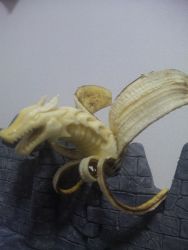Rule 34 | banana, dragon, fangs, food, food focus, fruit, highres, no humans, open mouth, photo (medium), reptile, scales, sculpture, wall, y yamaden