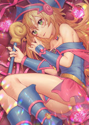 Rule 34 | 1girl, blonde hair, blue footwear, blush, boots, breasts, cleavage, dark magician girl, green eyes, hair between eyes, holding, holding staff, long hair, lying, magical girl, medium breasts, miniskirt, on side, parted lips, pink skirt, skirt, solo, staff, very long hair, wenz, yu-gi-oh!