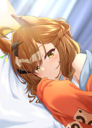 1girl absurdres ahoge animal_ears bed_sheet brown_hair closed_mouth curtains hair_ornament hairclip highres horse_ears indoors jacket jungle_pocket_(umamusume) light_blush looking_at_viewer lying medium_hair notched_ear off_shoulder on_side orange_jacket ryochapu shirt short_ponytail sleeves_past_fingers sleeves_past_wrists solo umamusume upper_body white_shirt yellow_eyes