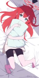 Rule 34 | 1girl, ahoge, barefoot, bed sheet, bike shorts, blue archive, blue eyes, bright pupils, commentary request, halo, highres, holding, holding pillow, long hair, looking at viewer, lying, maki (blue archive), millet pepper, on back, pillow, red hair, red halo, shirt, solo, toes, twitter username, white pupils, white shirt