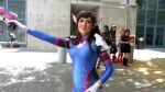 Rule 34 | animated, ass, bodysuit, brown hair, cosplay, d.va (overwatch), d.va (overwatch) (cosplay), from behind, latex, outdoors, overwatch, overwatch 1, photo (medium), weapon, video