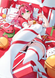 1girl 35p_(sakura_miko) alternate_costume bell black_panties blush breasts christmas closed_mouth commentary_request fur-trimmed_skirt fur_trim green_eyes hair_ornament hand_on_own_crotch hat highres hololive indoors jingle_bell kintoki_(sakura_miko) large_breasts long_hair looking_at_viewer lying mixed-language_commentary nyan_(reinyan_007) on_back on_bed panties pink_hair pom_pom_(clothes) pom_pom_hair_ornament puffy_short_sleeves puffy_sleeves red_hat red_ribbon red_skirt ribbon ribbon_as_bra sakura_miko santa_hat short_sleeves skirt tassel thighhighs thighs underboob underwear virtual_youtuber white_thighhighs