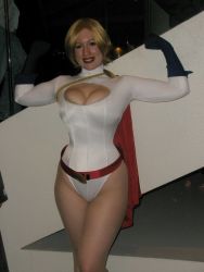 Rule 34 | 1girl, bellechere, blonde hair, breasts, cleavage, cosplay, dc comics, grin, highres, leotard, looking at viewer, photo (medium), power girl, smile, solo, standing, tagme, thighs
