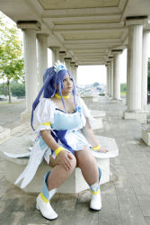 Rule 34 | 1girl, ankle boots, asian, blue eyes, blue hair, boots, bow, bracelet, breasts, choker, chouzuki maryou, cosplay, cure diamond (cosplay), dokidoki! precure, dress, headpiece, highres, jewelry, large breasts, long hair, magical girl, matching hair/eyes, photo (medium), plump, ponytail, precure, puffy short sleeves, puffy sleeves, ribbon, short sleeves, sitting, solo, tiara