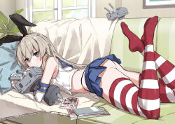 Rule 34 | 1girl, :3, ass, black hairband, blue skirt, blush, closed mouth, commentary request, couch, elbow gloves, gloves, grey eyes, grey hair, hairband, indoors, kantai collection, long hair, looking at viewer, lying, on couch, on stomach, rensouhou-chan, shimakaze (kancolle), skirt, smile, solo, striped clothes, striped thighhighs, takanashi kei (hitsujikan), thighhighs, white gloves, window