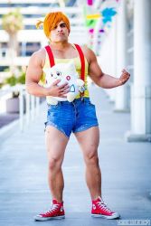 Rule 34 | blurry, blurry background, body hair, clenched hand, cosplay, creatures (company), full body, game freak, misty (pokemon), misty (pokemon) (cosplay), muscular, nintendo, photo (medium), pokemon, shoelaces, shoes, shorts, solo, standing