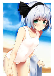Rule 34 | 1girl, bare arms, bare shoulders, beach, black hairband, black ribbon, blue sky, blush, border, breasts, collarbone, commentary request, covered navel, cowboy shot, day, green eyes, hair ribbon, hairband, highres, holding, holding towel, konpaku youmu, leaning forward, looking at viewer, nigo (aozoragarou), one-piece swimsuit, outdoors, outside border, portrait, ribbon, sand, shadow, short hair, silver hair, sky, small breasts, solo, standing, swimsuit, thighs, touhou, towel, water, white border, white one-piece swimsuit