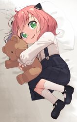 Rule 34 | 1girl, absurdres, ahoge, anya (spy x family), child, female focus, full body, green eyes, hair ornament, hairpods, highres, hugging object, jungki dr, long sleeves, looking at viewer, lying, mary janes, on bed, on side, parted lips, pillow, pink hair, shirt, shoes, short hair, skirt, smile, socks, solo, spy x family, stuffed animal, stuffed toy, suspender skirt, suspenders, teddy bear, white background, white shirt, white socks