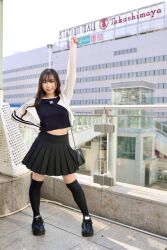Rule 34 | 1girl, black skirt, black socks, company logo, highres, photo (medium), skirt, socks, takashimaya, uniqlo