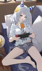 Rule 34 | 1girl, alternate costume, animal ears, barefoot, breasts, brown eyes, commentary request, couch, desk, ear covers, ear ornament, foot out of frame, grey hair, grey shorts, highres, hishi miracle (umamusume), horse ears, horse girl, horse tail, indoors, juice box, looking at viewer, medium breasts, medium hair, ningen gokko, nintendo switch, on couch, open mouth, pillow, shirt, short shorts, short sleeves, shorts, smile, solo, tail, umamusume, white shirt