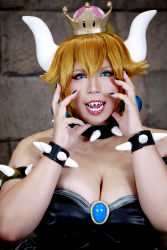 Rule 34 | 1girl, armlet, asian, bare shoulders, black collar, black dress, black nails, blonde hair, blue eyes, borrowed design, bowsette, bowsette (cosplay), bracelet, breasts, brooch, chouzuki maryou, cleavage, collar, cosplay, crown, dress, earrings, fingernails, highres, horns, jewelry, large breasts, long hair, looking at viewer, mario (series), nail polish, new super mario bros. u deluxe, nintendo, photo (medium), plump, shell, skirt, smile, solo, spiked armlet, spiked bracelet, spiked collar, spiked shell, spikes, standing, strapless, strapless dress, super crown, turtle shell