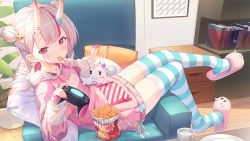 Rule 34 | 1girl, animal print, beige hoodie, blush, book, breasts, cat hair ornament, cat print, chair, closed mouth, coffee cup, collarbone, commentary request, controller, cup, disposable cup, double bun, fang, fingernails, food, food in mouth, full body, game controller, gamepad, hair bun, hair ornament, highres, hitokuchii, holding, holding controller, holding game controller, hololive, hood, hood down, hoodie, horns, indoors, long hair, long sleeves, looking at viewer, lying, mouth hold, multicolored clothes, multicolored hair, multicolored hoodie, nachos, nail polish, nakiri ayame, oni, open mouth, pillow, pink hoodie, plant, potted plant, poyoyo (nakiri ayame), red eyes, red hair, red nails, silver hair, sitting, skin-covered horns, skin fang, sleeves past wrists, slippers, smile, solo, streaked hair, striped clothes, striped thighhighs, table, thighhighs, virtual youtuber, wooden floor