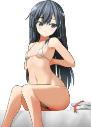 1girl arms_behind_back asashio_(kancolle) bed bikini black_hair blue_eyes box breasts cowboy_shot feet_out_of_frame female_focus kantai_collection kuronaga long_hair micro_bikini simple_background sitting small_breasts solo swimsuit white_background white_bikini