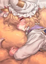 Rule 34 | 1girl, animal ear fluff, animal ears, animal hat, bed sheet, blonde hair, blush, commentary request, dress, fox ears, fox tail, frilled shirt collar, frills, hat, highres, hugging own tail, hugging tail, long sleeves, looking at viewer, masanaga (tsukasa), mob cap, short hair, smile, solo, tail, touhou, upper body, white dress, white hat, yakumo ran, yellow eyes
