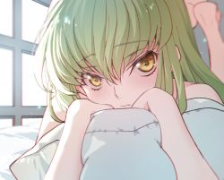 Rule 34 | 1girl, blurry, blurry background, c.c., closed mouth, code geass, creayus, green hair, hair between eyes, leg up, long hair, looking at viewer, lying, hugging object, on stomach, pillow, pillow hug, sidelocks, solo, sunlight, window, yellow eyes