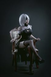 Rule 34 | 1girl, blindfold, chair, cosplay, dress, high heels, nier (series), nier:automata, photo (medium), short hair, thighhighs, white hair, 2b (nier:automata), 2b (nier:automata) (cosplay)