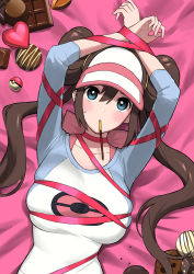 Rule 34 | 1girl, absurdres, arms up, bed sheet, blue eyes, blush, bound, bound wrists, breasts, brown hair, candy, chocolate, chocolate heart, cookie, creatures (company), double bun, food, food in mouth, game freak, hair bun, hat, heart, highres, large breasts, long sleeves, looking at viewer, lying, mouth hold, nintendo, nishikino kee, on back, pocky, poke ball, poke ball (basic), poke ball print, pokemon, pokemon bw2, raglan sleeves, red ribbon, ribbon, ribbon bondage, rosa (pokemon), solo, sweatdrop, twintails, upper body, valentine, visor cap