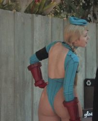 Rule 34 | 1girl, animated, animated gif, ass, beret, blonde hair, braid, cammy white, cammy white (cosplay), capcom, cosplay, hand on own hip, happy, hat, highleg, highleg leotard, huge ass, ikuy, leotard, long hair, looking back, lowres, no bra, outdoors, photo (medium), sakuracon, smile, street fighter, twin braids
