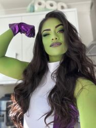 Rule 34 | 1girl, breasts, clenched hand, colored skin, cosplay, fingerless gloves, full body, gloves, green hair, green skin, highres, leotard, lips, looking at viewer, marvel, medium breasts, photo (medium), purple leotard, she-hulk, she-hulk (cosplay), simple background, smile, two-tone leotard, upper body, wide hips, zoogirlq