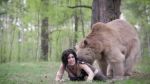 Rule 34 | 1girl, animal, animated, bear, black hair, blush, breasts, cosplay, costume, downblouse, forest, grass, highres, lara croft, large breasts, long hair, looking at viewer, looking back, lying, nature, on stomach, outdoors, photo (medium), tomb raider, tomb raider (reboot), tree, video