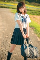 Rule 34 | 1girl, bag, bare arms, black eyes, black skirt, black socks, blunt bangs, breasts, brown hair, closed mouth, commentary request, day, feet out of frame, field, head tilt, highres, holding, ieneko (cosplayer), kneehighs, light smile, looking at viewer, medium breasts, medium hair, medium skirt, neckerchief, original, outdoors, photo (medium), pleated skirt, reference photo, sailor collar, school bag, school uniform, serafuku, shirt, short sleeves, shoulder bag, skirt, smile, socks, solo, standing, white sailor collar, white shirt