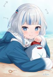 Rule 34 | 1girl, :q, a (phrase), animal hood, beach, bloop (gawr gura), blue eyes, blue hair, blue hoodie, blush, closed mouth, commentary, gawr gura, gawr gura (1st costume), hair ornament, highres, hitsukuya, hololive, hololive english, hood, hood down, hoodie, looking at viewer, lying, multicolored hair, on stomach, sand, shark hood, signature, silver hair, smile, streaked hair, tongue, tongue out, two side up, upper body, virtual youtuber, water