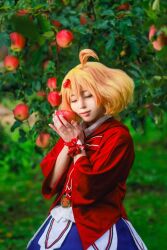 1girl apple belt blue_skirt bow brown_belt collared_shirt cosplay_photo food freyja_wion fruit hair_behind_ear hair_ornament heart heart_hair_ornament holding holding_food holding_fruit jacket macross macross_delta orange_hair photo_(medium) pink_lips red_bow red_jacket shirt short_hair skirt smile solo white_shirt zakuro_(zaku_f09)