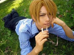 Rule 34 | 1boy, blonde hair, blue shirt, collared shirt, cosplay, glasses, hair over one eye, hand rest, lowres, male focus, one piece, photo (medium), sanji (one piece), sanji (one piece) (cosplay), shirt, solo