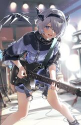 Rule 34 | 1girl, black hairband, blue eyes, blue shirt, blue shorts, blurry, blurry background, blush, cable, commentary, dragon girl, dragon horns, dragon tail, film grain, grey hair, guitar, hair over one eye, hairband, highres, holding, holding instrument, holding plectrum, horns, indoors, instrument, light particles, looking at viewer, nik ibi, open mouth, original, playing guitar, plectrum, shirt, short hair, shorts, sleeves past elbows, solo, stage lights, standing, symbol-only commentary, tail, teeth, upper teeth only, zipper, zipper pull tab