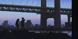 Rule 34 | 2girls, alzi xiaomi, arms behind back, blue sky, blurry, blurry foreground, bridge, building, city, dusk, from behind, full body, highres, lamppost, long hair, multiple girls, original, outdoors, scenery, shirt, short hair, silhouette, skirt, sky, skyline, standing