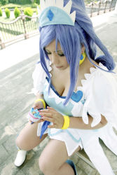 Rule 34 | 1girl, ankle boots, asian, blue eyes, blue hair, boots, bow, bracelet, breasts, cellphone, choker, chouzuki maryou, cleavage, cosplay, cure diamond, cure diamond (cosplay), dokidoki! precure, dress, earrings, headpiece, highres, jewelry, large breasts, long hair, magical girl, matching hair/eyes, phone, photo (medium), plump, ponytail, precure, puffy short sleeves, puffy sleeves, ribbon, short sleeves, sitting, solo, tiara