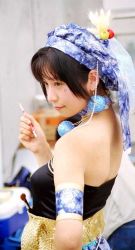 Rule 34 | 1girl, armlet, bare shoulders, black hair, blue hat, blunt bangs, blurry, blurry background, breasts, brown eyes, closed mouth, collar, cosplay, cosplay photo, earrings, final fantasy, final fantasy vi, from side, hat, hat feather, holding, jewelry, looking at another, looking to the side, paintbrush, photo (medium), relm arrowny, sash, short hair, shoulder blades, skindentation, small breasts, smile, solo, strapless, upper body