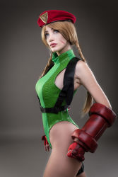 Rule 34 | 1girl, absurdres, argentine (nationality), ass, bare legs, bare shoulders, blonde hair, braid, cammy white, cammy white (cosplay), capcom, cosplay, curvy, fingernails, gloves, green leotard, hat, highleg, highleg leotard, highres, huge ass, leotard, lips, long hair, looking to the side, photo (medium), real life, shiny clothes, simple background, skindentation, solo, sophie valentine, standing, street fighter, street fighter v, twin braids, very long hair, wide hips
