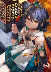 1girl :t black_hair blue_skirt blurry blurry_foreground breasts bridal_gauntlets closed_mouth commentary dango depth_of_field eating food glint green_hair hair_between_eyes hair_ornament hand_up highres holding holding_food honkai:_star_rail honkai_(series) ikazu401 looking_at_viewer multicolored_hair nail_polish orange_eyes pleated_skirt red_nails sitting skirt small_breasts solo streaked_hair tiara wagashi yunli_(honkai:_star_rail)