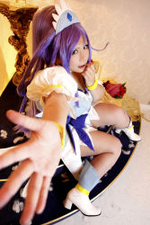 Rule 34 | 1girl, ankle boots, asian, blue eyes, blue hair, boots, bow, bracelet, breasts, choker, chouzuki maryou, cosplay, cure diamond (cosplay), dokidoki! precure, dress, headpiece, highres, jewelry, large breasts, long hair, magical girl, matching hair/eyes, photo (medium), plump, ponytail, precure, puffy short sleeves, puffy sleeves, reaching, ribbon, short sleeves, sitting, solo, tiara