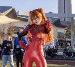 Rule 34 | cosplay, formal, glico happy, highres, neon genesis evangelion, photo (medium), pointing, pointing at viewer, red suit, souryuu asuka langley, souryuu asuka langley (cosplay), suit