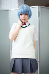 Rule 34 | 1girl, alternate costume, asian, ayanami rei, blue hair, breasts, color contacts, cosplay, grey skirt, highres, indoors, looking at viewer, miniskirt, namada, necktie, neon genesis evangelion, photo (medium), pleated skirt, red eyes, red necktie, school uniform, shirt, short hair, short sleeves, skirt, small breasts, socks, solo, standing, sweater vest, white shirt