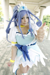 Rule 34 | 1girl, ankle boots, asian, blue eyes, blue hair, boots, bow, bracelet, breasts, choker, chouzuki maryou, cosplay, cure diamond, cure diamond (cosplay), dokidoki! precure, dress, headpiece, highres, jewelry, large breasts, long hair, magical girl, matching hair/eyes, photo (medium), plump, ponytail, precure, puffy short sleeves, puffy sleeves, ribbon, short sleeves, solo, thumbs up, tiara