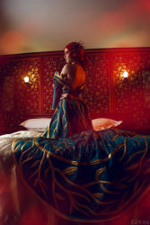 Rule 34 | 1girl, bed, bedroom, blurry, braid, circlet, cosplay, costume, depth of field, dress, eyeliner, eyeshadow, freckles, full body, hair ornament, helly von valentine (disharmonica), highres, indoors, jewelry, kneeling, lens flare, looking afar, makeup, necklace, no bra, on bed, parted lips, pendant, photo (medium), pillow, red hair, robe, side braids, solo, the witcher (series), triss merigold, triss merigold (cosplay), undressing
