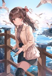 Rule 34 | 1girl, bag, beige jacket, bird, black skirt, black thighhighs, blunt bangs, blush, breasts, brown hair, brown shirt, cellphone, closed mouth, cloud, contrapposto, day, feet out of frame, hair ribbon, handbag, highres, holding, holding phone, long hair, looking at viewer, nanna (heyj2888), ocean, original, outdoors, over-kneehighs, phone, pom pom (clothes), railing, red ribbon, ribbon, rock, seagull, shirt, skirt, small breasts, smartphone, smile, solo, standing, thighhighs, water